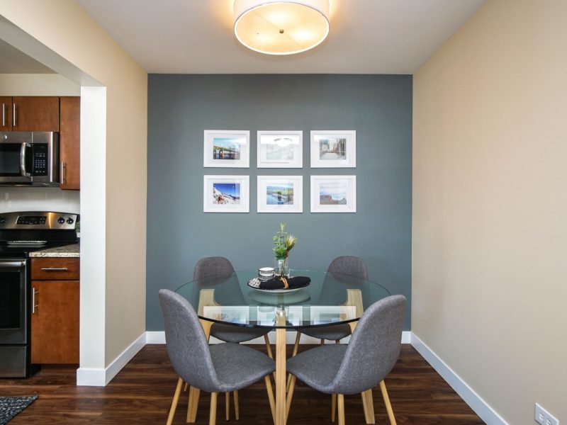 This image shows an expansive view of the Premium Apartment Feature, especially the dining area showcasing the warm ambiance and minimal wall decors.