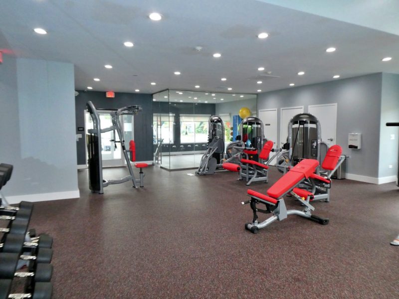This image shows an expansive view of the 24-hour State-of-the-art fitness gym featuring different equipment that is essential for community amenities. The Athletic Club is offering fitness equipment that is ideal for every fitness enthusiast and professionals.