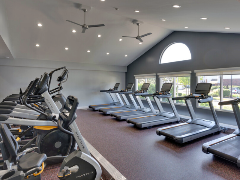This picture is showing the TGM Danada Apartments fitness gym area with treadmill equipment which is basically a piece of a machine designed for running in the same space via the use of a rotating belt.